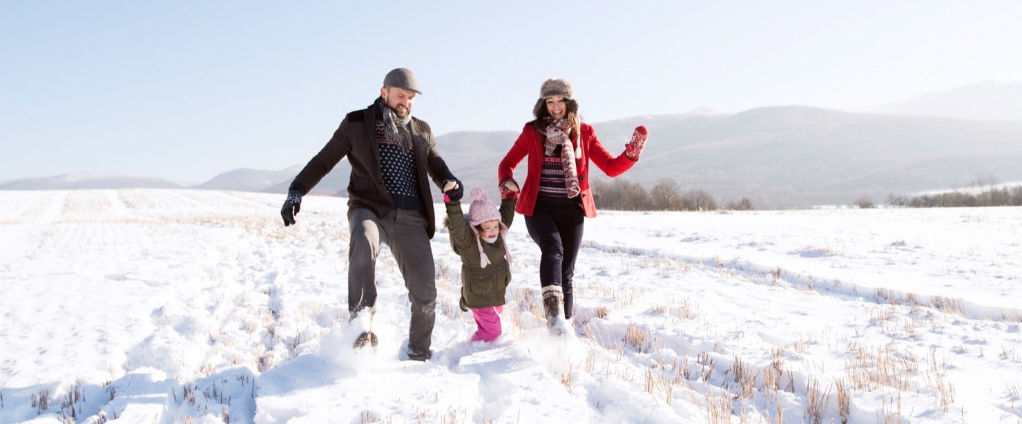 family walking in the snow