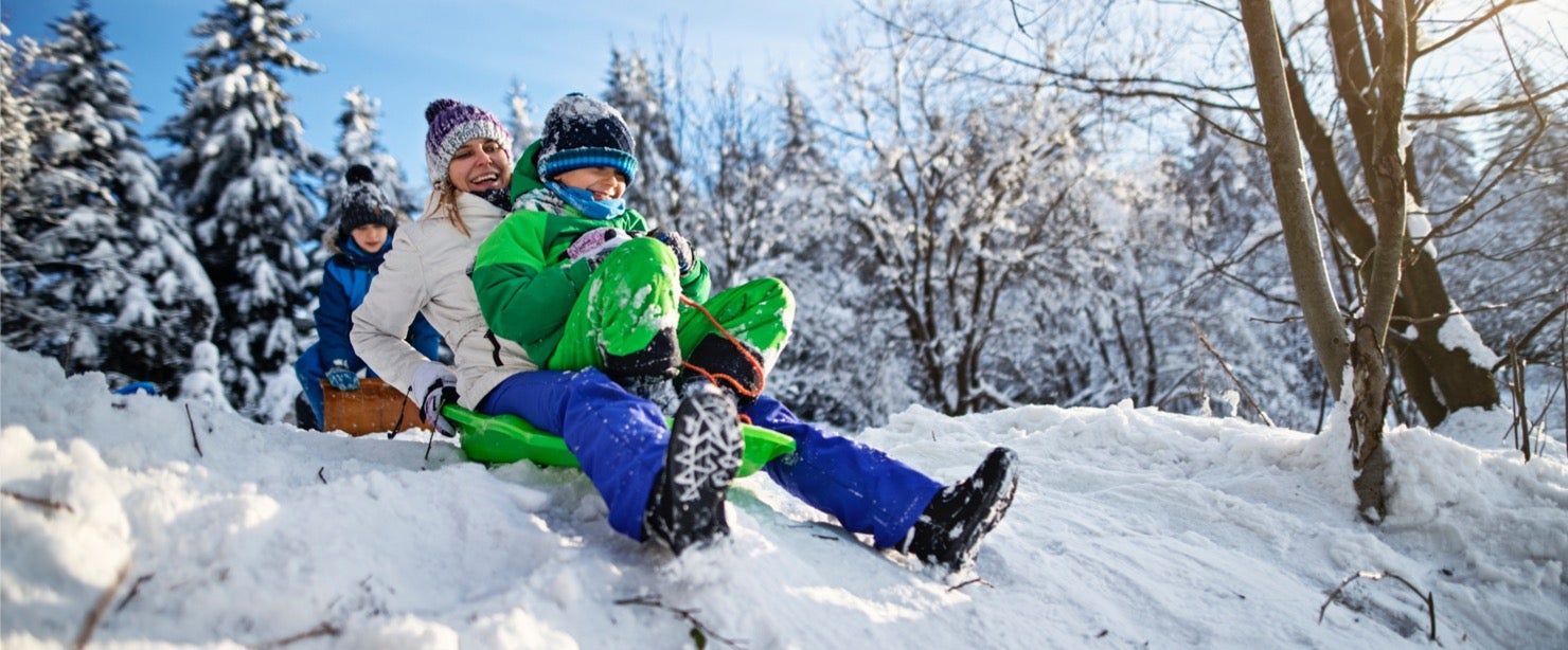 mother and kids sledding
