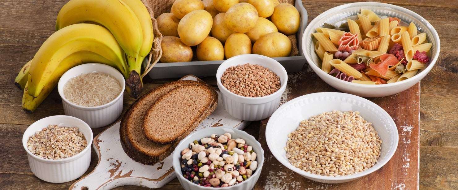 foods high in carbohydrates on wooden background