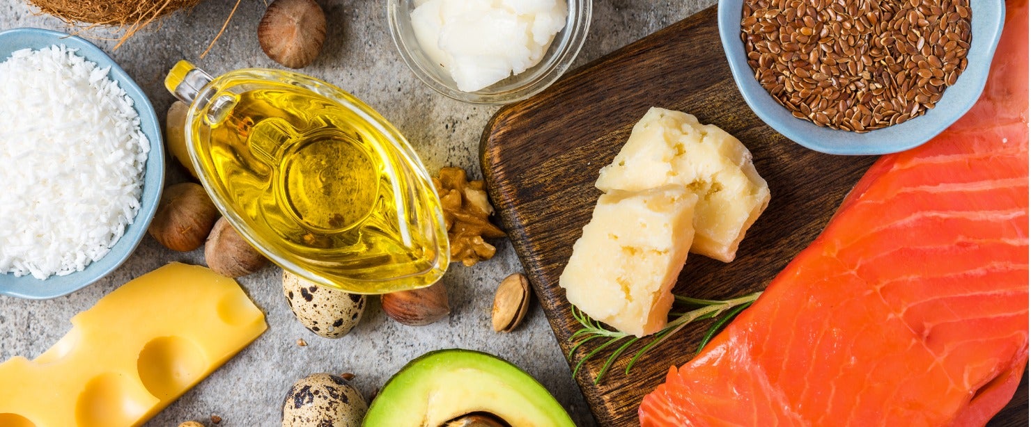 foods high in healthy fats on stone background