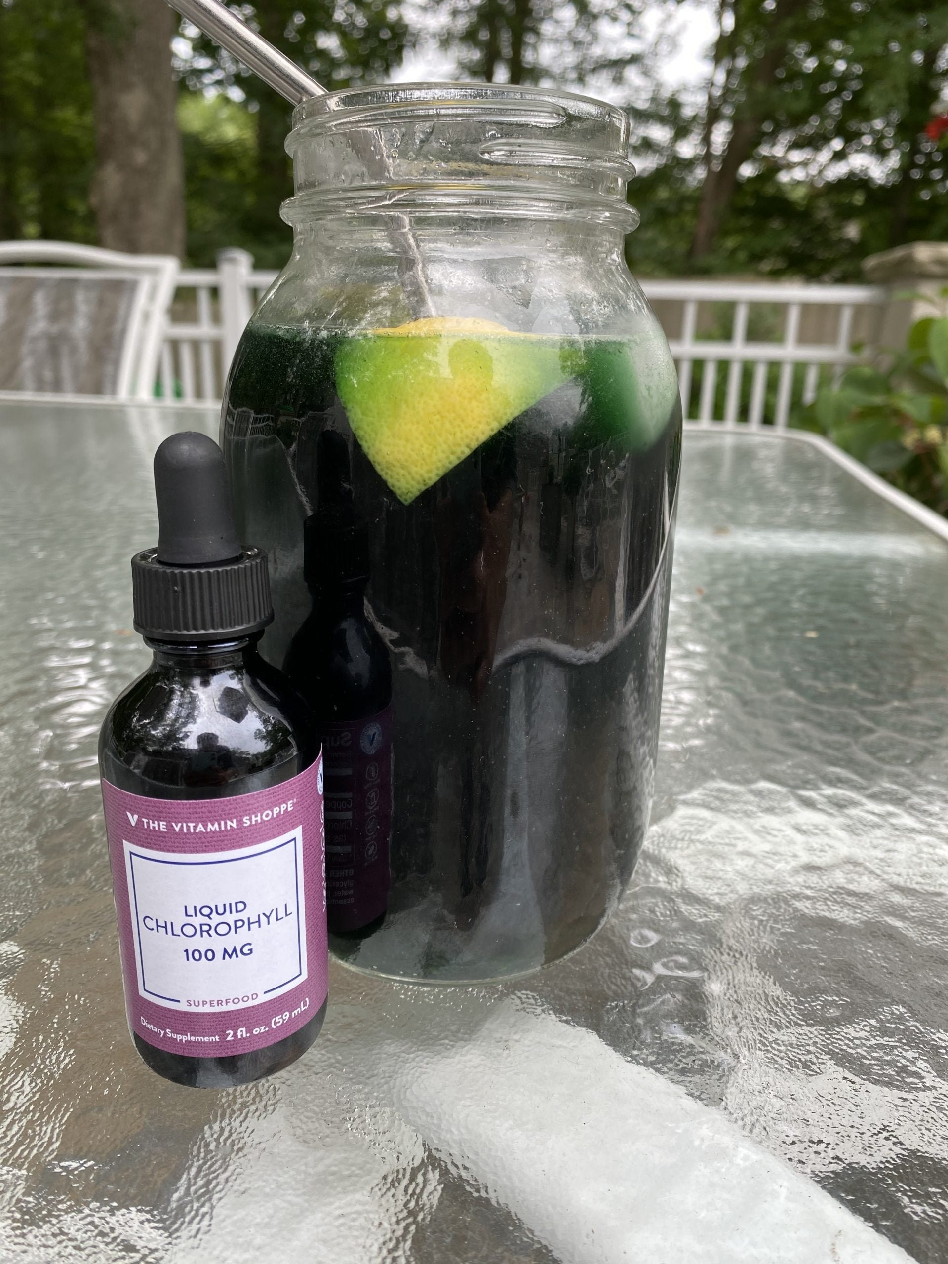 jar of green water and a bottle of liquid chlorophyll