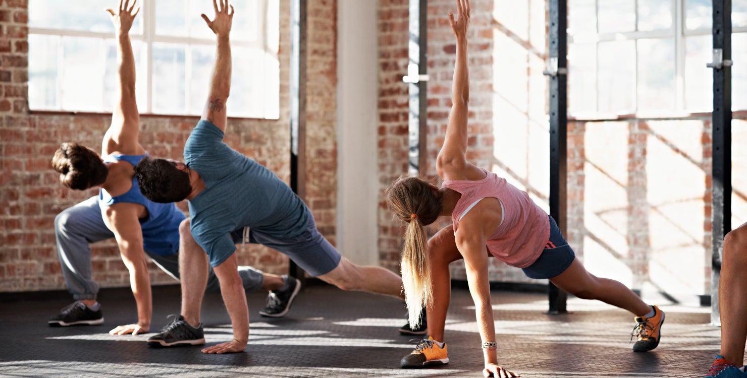 Shot of a group of people doing some strength training in a fitness class