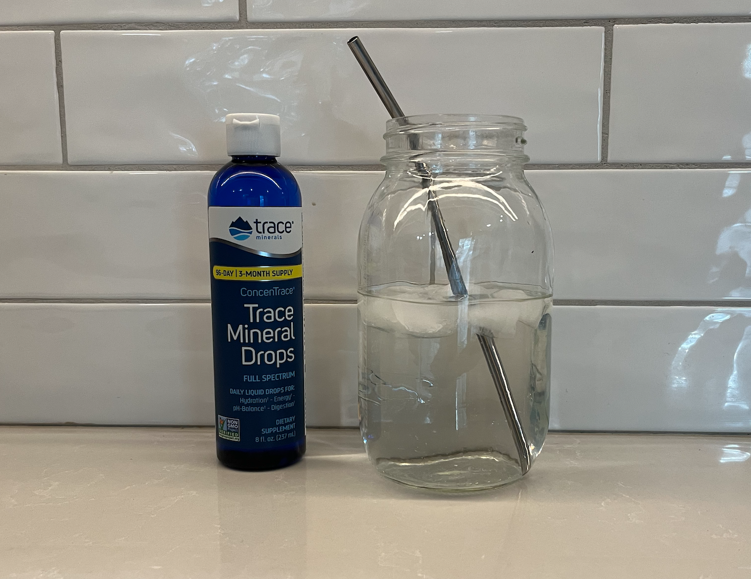 bottle of trace minerals with jar of water