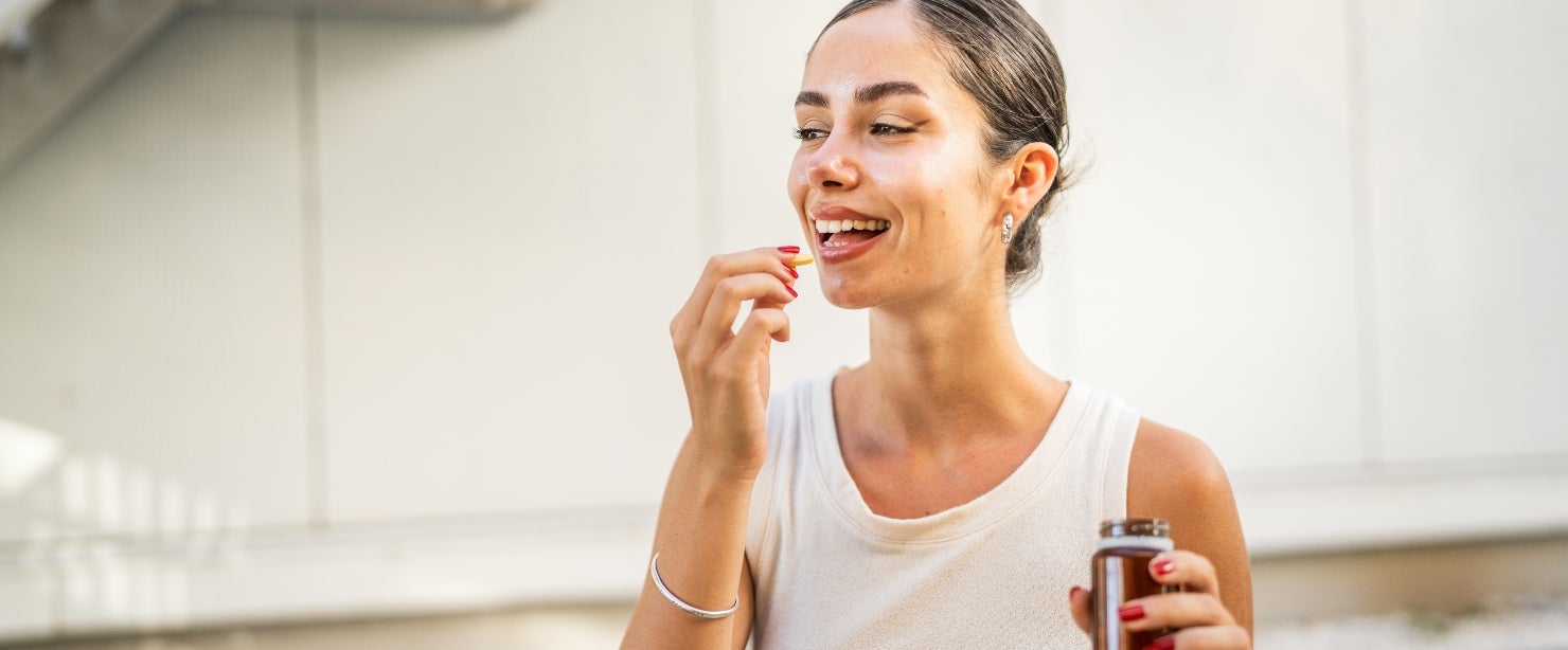 magnesium complex supplements: young woman taking pill