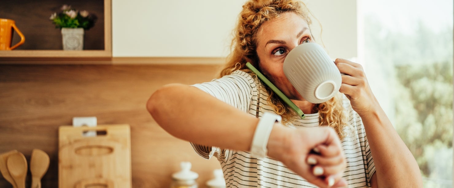 chronic busyness affects body: busy woman drinking coffee