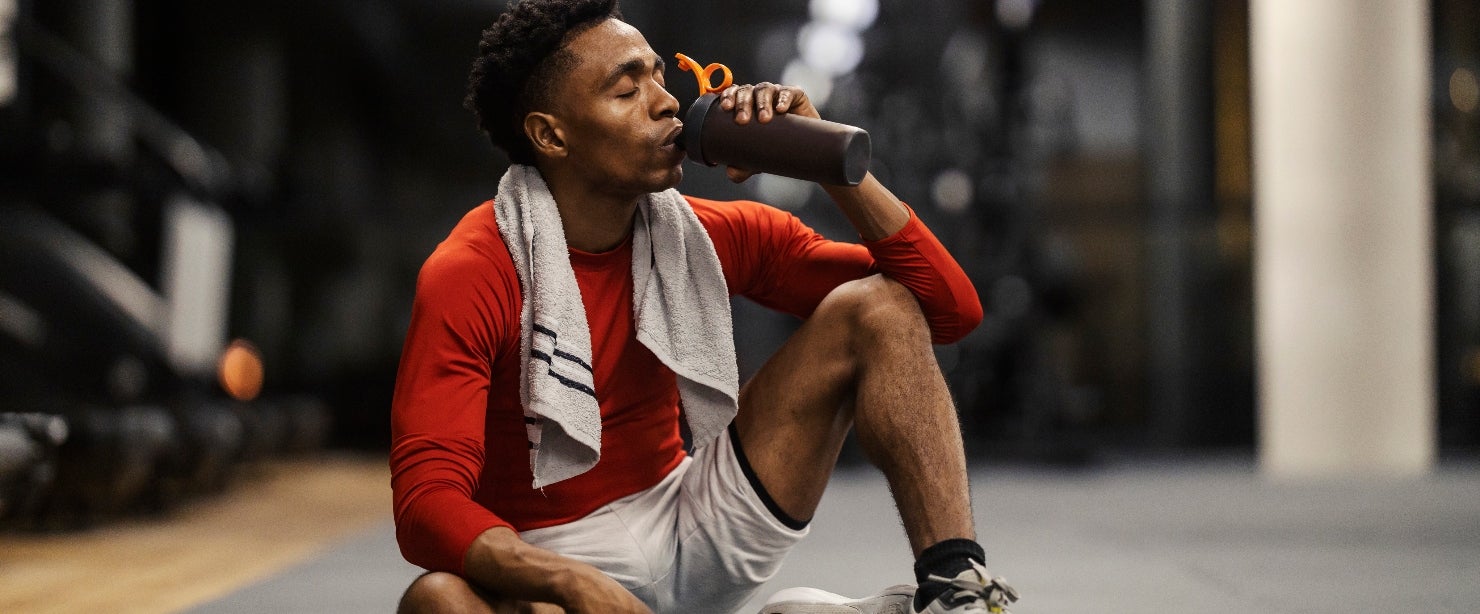 recovery supplements: man drinking after workout