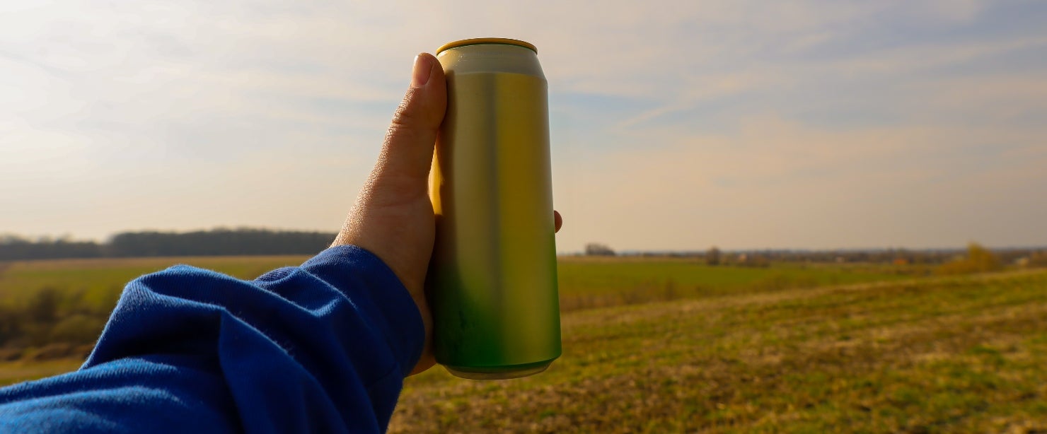 energy drinks empty stomach: hand holding energy drink can