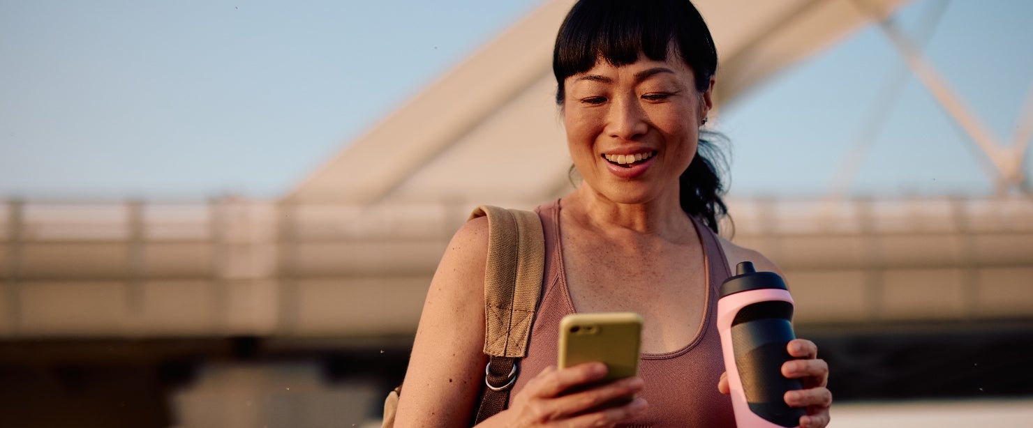 creatine benefits older women: woman walking phone water bottle