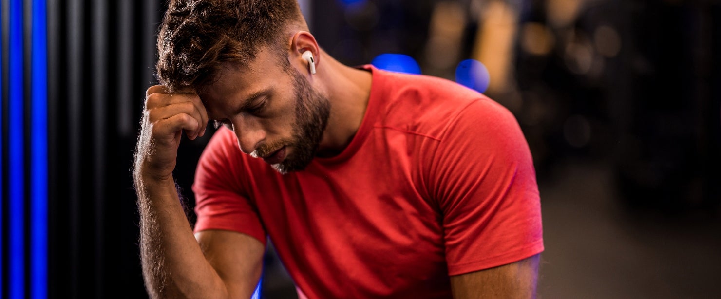 metabolism mood: fit man tired stressed gym